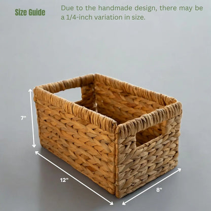 Rectangular woven wicker basket with side handles, measuring 12 inches in length, 8 inches in width, and 7 inches in height. The text highlights a size guide noting a possible 1/4-inch variation due to the handmade design.